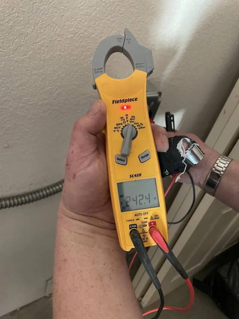 Voltage testing with clamp meter during Recessed Lighting Installation in Cornelia